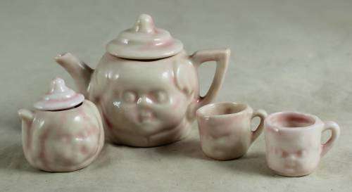 PINK KIDS TEA SET WITH A BABY FACE IMPRINT(LOVELY)BID NOW!!