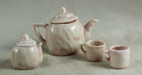 PINK KIDS TEA SET WITH A BABY FACE IMPRINT(LOVELY)BID NOW!!