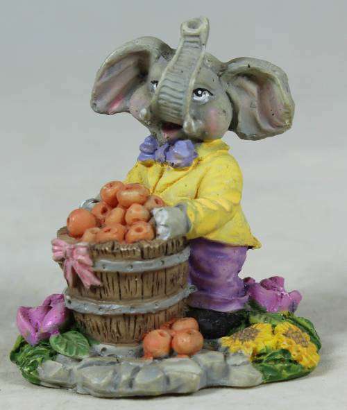 Small elephant with basket of oranges