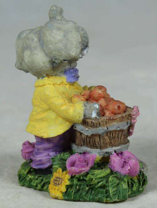 Small elephant with basket of oranges