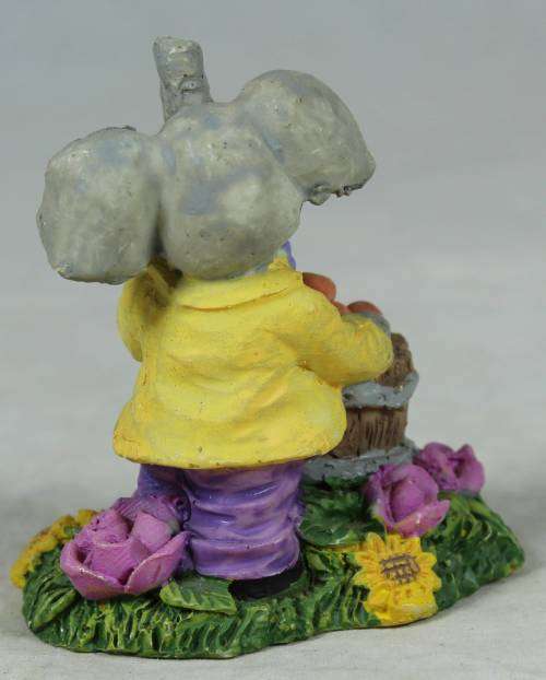 Small elephant with basket of oranges