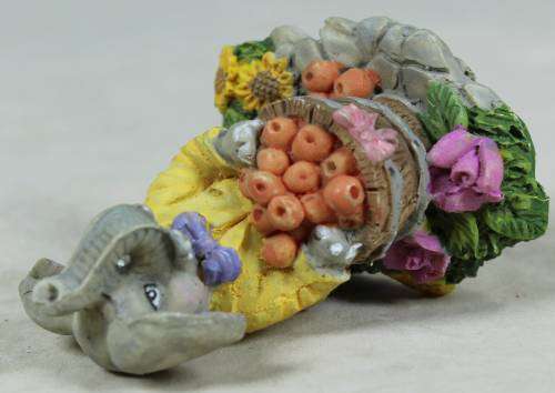 Small elephant with basket of oranges