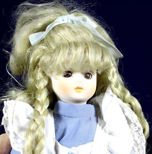 Porcelain doll - girl with pigtails in blue dress