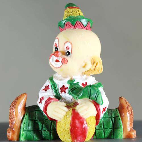 Small clown figurine baby with a ball