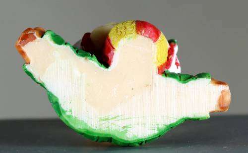 Small clown figurine baby with a ball