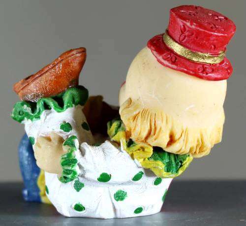 Small clown figurine kid putting on his shoe