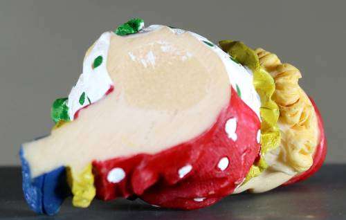 Small clown figurine kid putting on his shoe