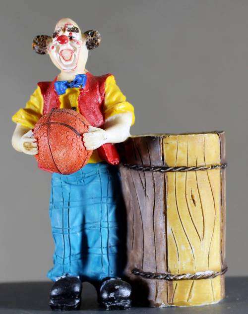 Small clown figurine with basketball and large barrel