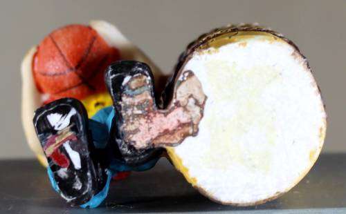 Small clown figurine with basketball and large barrel