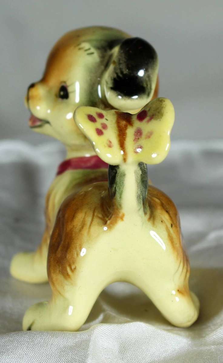 Puppy with butterfly on tail