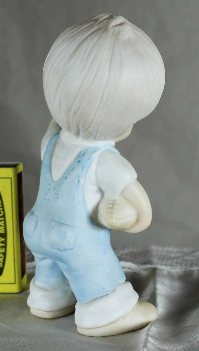 Vintage little boy with rugby ball