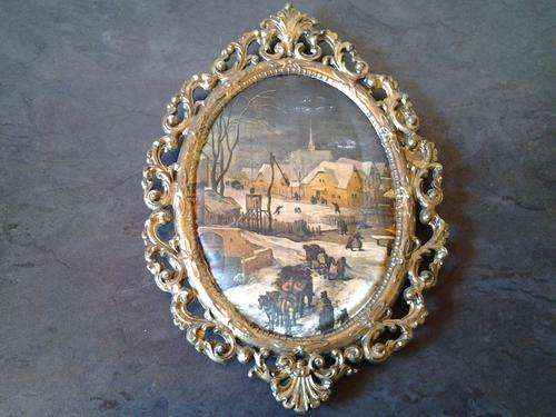 A vintage Brass Filigree frame with a satin padded "winter in Switzerland"  setting. So ornate.