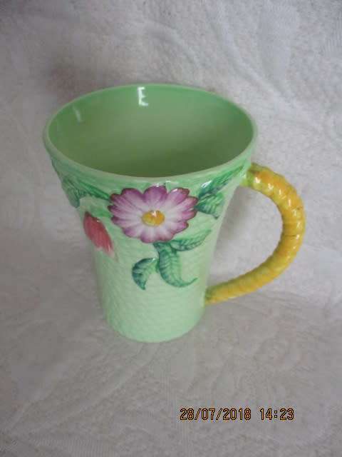 Carlton ware mug in mint green and yellow, embossed with flowers