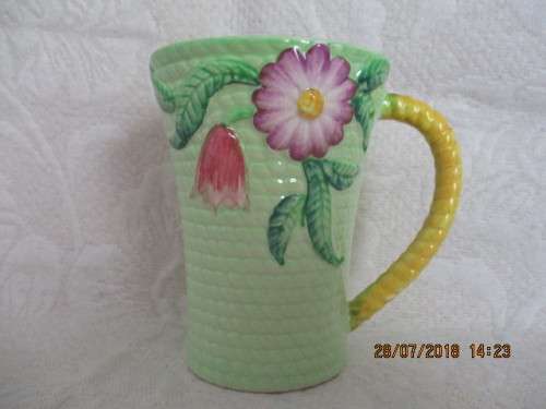 Carlton ware mug in mint green and yellow, embossed with flowers