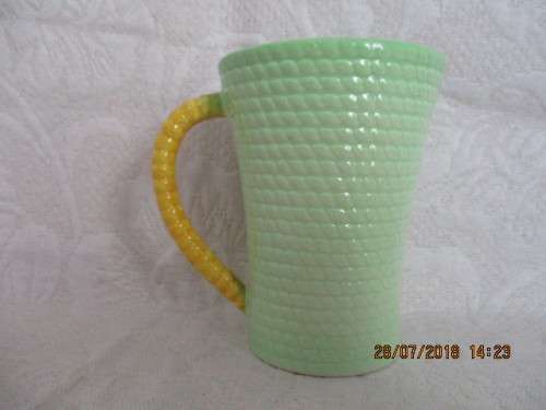 Carlton ware mug in mint green and yellow, embossed with flowers