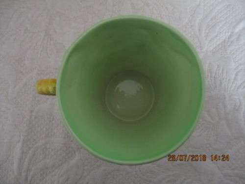 Carlton ware mug in mint green and yellow, embossed with flowers