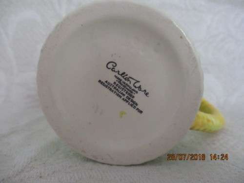 Carlton ware mug in mint green and yellow, embossed with flowers