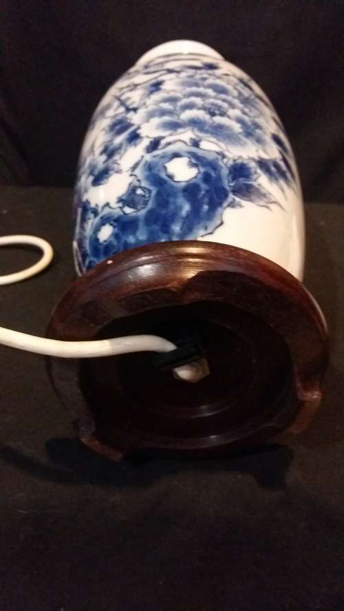 Stunning Oriental Blue and White Porcelain Lamp on carved wooden Base.