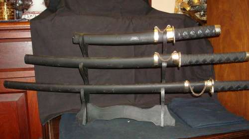 STUNNING SET OF METAL SAMURAI SWORDS ON A DISPLAY STAND