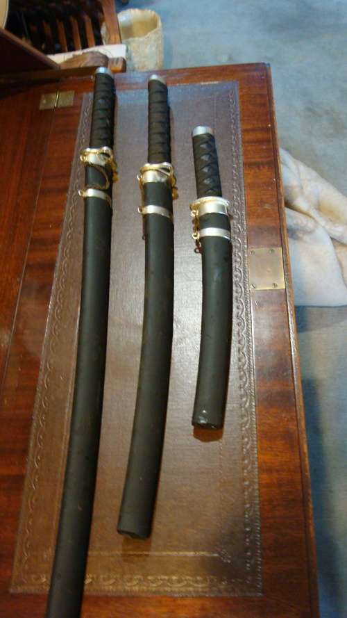 STUNNING SET OF METAL SAMURAI SWORDS ON A DISPLAY STAND