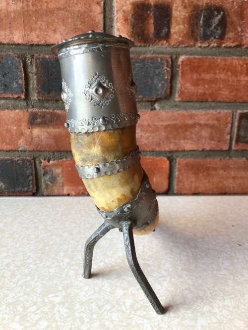 A pewter mounted powder horn with removable top, with engravings and embossed decoration
