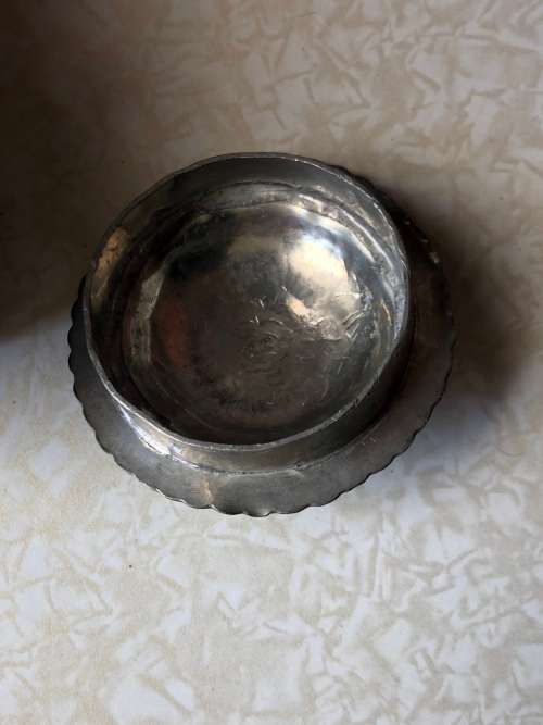 A pewter mounted powder horn with removable top, with engravings and embossed decoration