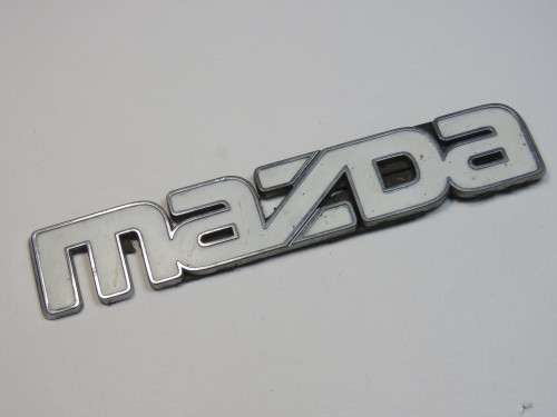 Vintage Mazda car badge - White on silver - Plastic