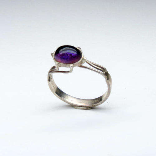 Silver ring with purple stone in