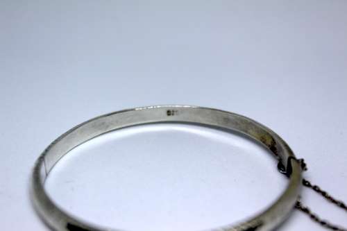 Vintage Sterling Silver Bangle with detail and safety chain. 20cm diametre