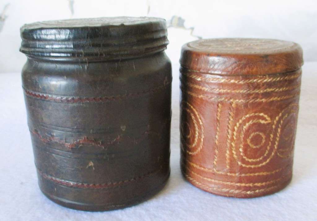 Prisoner of war trench art leather covered cigarette tins. 100mm and 85mm high. Very collectable