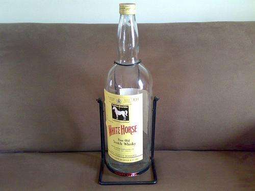 WHITE HORSE SCOTCH WHISKEY BOTTLE ON ORIGINAL STAND