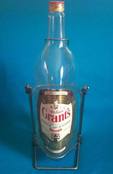LARGE GRANT'S SCOTCH WHISKY BOTTLE ON STAND
