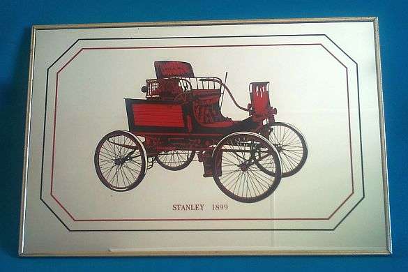 FRAMED MIRROR WALL PLAQUE DEPICTING VINTAGE "STANLEY 1899" CAR