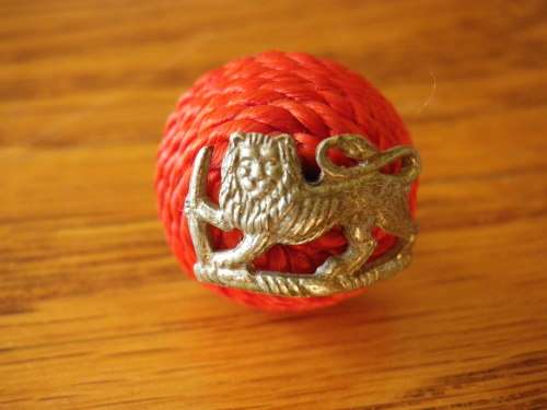 RHODESIA REGT OFFICERS SILVER MESS DRESS BADGE MOUNTED ON SCARLET SILK CORDED BOSS. UDI PERIOD