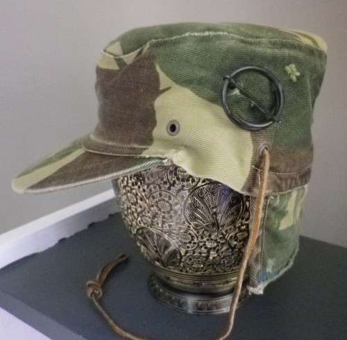 RHODESIAN -  CAMO CAP - PART OF FLAP CUT OFF BY OWNER - HAS ORIGINAL ORANGE LINING -  (5454)
