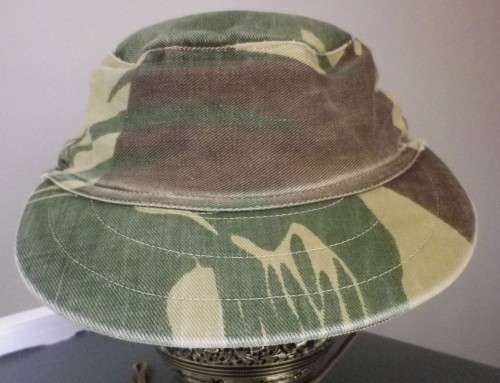 RHODESIAN -  CAMO CAP - PART OF FLAP CUT OFF BY OWNER - HAS ORIGINAL ORANGE LINING -  (5454)