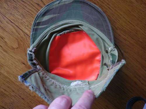 RHODESIAN -  CAMO CAP - PART OF FLAP CUT OFF BY OWNER - HAS ORIGINAL ORANGE LINING -  (5454)
