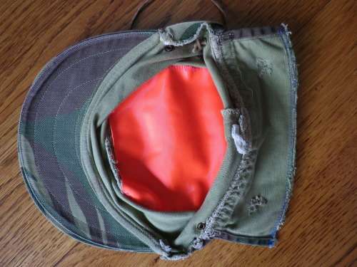 RHODESIAN -  CAMO CAP - PART OF FLAP CUT OFF BY OWNER - HAS ORIGINAL ORANGE LINING -  (5454)
