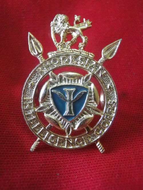 RHODESIAN INTELLIGENCE CORPS. - GOLD ANODISED + ENAMEL  CAP BADGE    (7758)