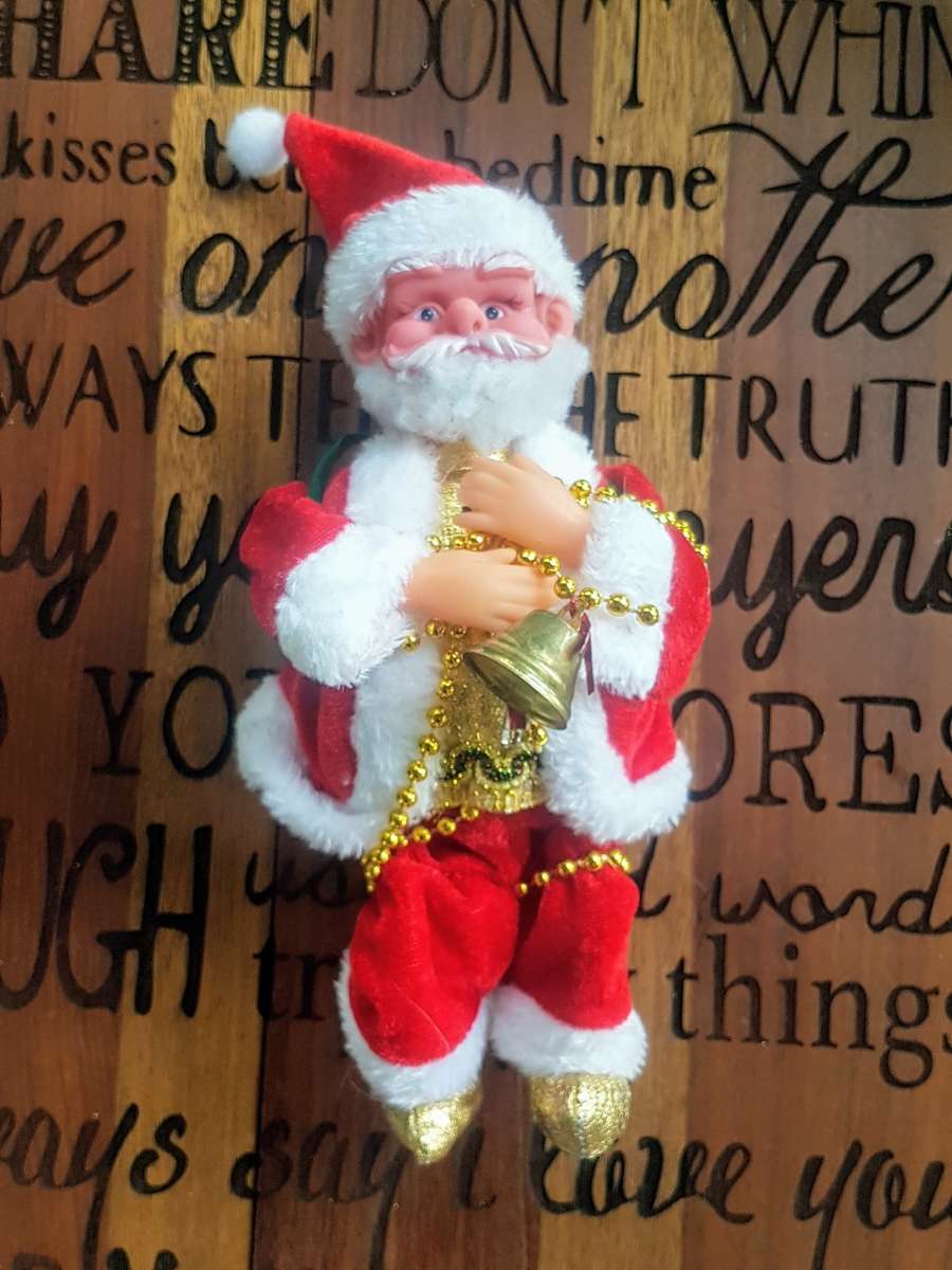 Father Christmas figurine Needs batteries Lights up and plays Christmas music