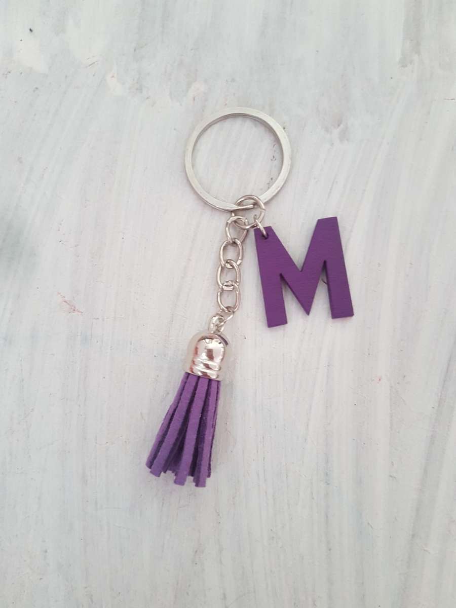 Keyring with purple initial M and tassel It could also be hung onto a handbag as a handbag accessory