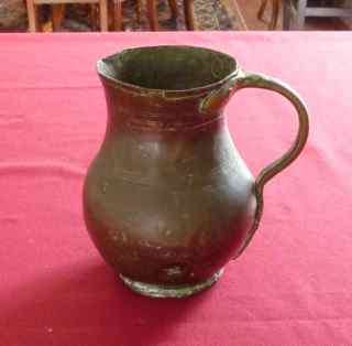 Old hand beaten copper jug