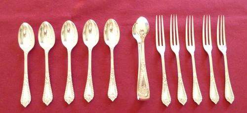 Decorative set of teaspoons, cake forks and tongs