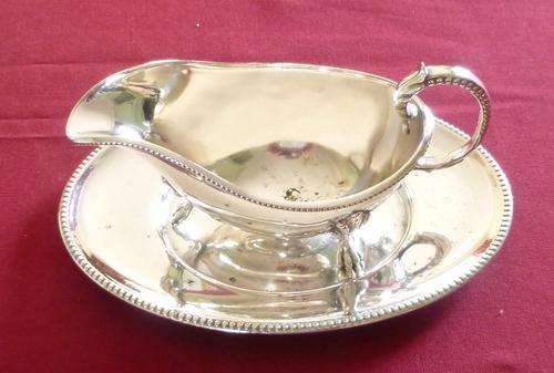 Silver plated sauce boat on tray