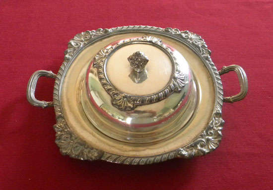 A silver plated butter dish and cover