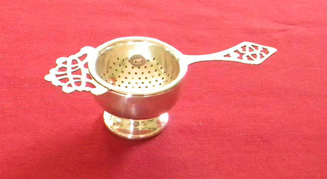 Silver plated teas strainer and stand