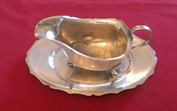 Silver gravy boat on stand