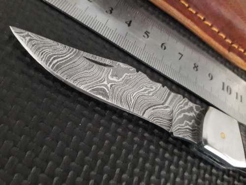 Handmade Damascus steel folding knife with Wooden handle scales.