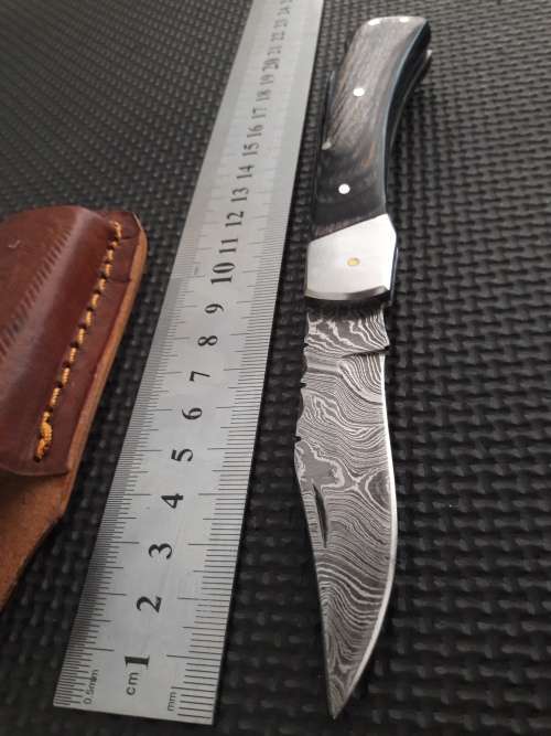 Handmade Damascus steel folding knife with Wooden handle scales.