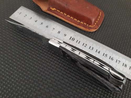 Handmade Damascus steel folding knife with Wooden handle scales.